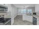 Updated kitchen featuring white cabinets, stainless appliances, and a view to the breakfast area at 185 Stewart Glen Dr, Covington, GA 30014
