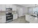 Bright, updated kitchen with white cabinetry, stainless steel appliances, and views into breakfast nook at 185 Stewart Glen Dr, Covington, GA 30014