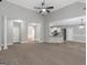 Open-concept living room featuring neutral colors, high ceilings, and seamless flow into the modern kitchen area at 185 Stewart Glen Dr, Covington, GA 30014