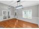 Spacious living room with hardwood floors, double French doors, and ample natural light at 185 Stewart Glen Dr, Covington, GA 30014