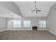 Spacious living room with fireplace, ceiling fan, and large windows for natural light at 185 Stewart Glen Dr, Covington, GA 30014