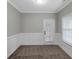 Neutral room with wainscoting, carpet, and a door leading outside at 185 Stewart Glen Dr, Covington, GA 30014