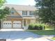 Inviting two-story home with a two-car garage, stone facade, and well-maintained front lawn at 4750 Crinklepoint Ct, Douglasville, GA 30134