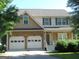 Charming two-story home featuring a two-car garage, stone accents, and lovely landscaping at 4750 Crinklepoint Ct, Douglasville, GA 30134