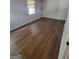 Bedroom features wood look floors and natural light from a single window at 5579 Marbut Rd, Lithonia, GA 30058
