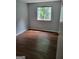 Bedroom has wood look floors and a single window for natural light at 5579 Marbut Rd, Lithonia, GA 30058