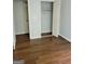 Bedroom featuring wood look flooring with closet and doors open at 5579 Marbut Rd, Lithonia, GA 30058