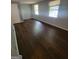 Bedroom features wood look flooring and dual windows for natural light at 5579 Marbut Rd, Lithonia, GA 30058