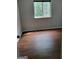 Bedroom has wood look floors and a single window for natural light at 5579 Marbut Rd, Lithonia, GA 30058