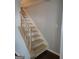 Carpeted staircase leading to the upper level of the home at 5579 Marbut Rd, Lithonia, GA 30058