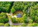 Bird's eye view of a cozy home nestled among lush green trees, showcasing its inviting curb appeal at 5525 Belle Meade Dr, Villa Rica, GA 30180