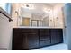 Bathroom with large mirror, double sink vanity, and dark wood cabinets at 5525 Belle Meade Dr, Villa Rica, GA 30180