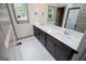 Elegant bathroom featuring double sinks, quartz countertop, and dark cabinetry at 5525 Belle Meade Dr, Villa Rica, GA 30180