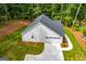 An aerial shot of a home showing the well-manicured lawn, driveway, attached garage and roof at 5525 Belle Meade Dr, Villa Rica, GA 30180
