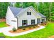 Well-maintained single-story home with a side garage, complemented by a lush green lawn and manicured landscaping at 5525 Belle Meade Dr, Villa Rica, GA 30180