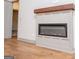 Modern fireplace with a dark mantel and hearth complemented by the hardwood floors of this living space at 5525 Belle Meade Dr, Villa Rica, GA 30180