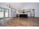 Modern kitchen with stainless steel appliances, gray cabinetry, a dark-colored island, and hardwood floors at 5525 Belle Meade Dr, Villa Rica, GA 30180
