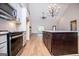 Open-concept kitchen with a large island, stainless appliances, and a view to the living area at 5525 Belle Meade Dr, Villa Rica, GA 30180