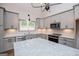 Bright kitchen features an island, stainless appliances, granite countertops, and soft-close cabinets at 5525 Belle Meade Dr, Villa Rica, GA 30180