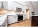 Well-lit kitchen features white cabinets, stainless steel appliances, and granite countertops at 5525 Belle Meade Dr, Villa Rica, GA 30180