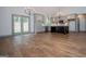 Open-concept kitchen and dining area featuring gray cabinetry, a dark-colored island, and hardwood floors at 5525 Belle Meade Dr, Villa Rica, GA 30180