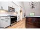 Well-lit open kitchen features granite countertops, stainless appliances, an island, and ample cabinet space at 5525 Belle Meade Dr, Villa Rica, GA 30180