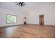 Spacious living room with vaulted ceiling, hardwood floors, and a large window offering ample natural light at 5525 Belle Meade Dr, Villa Rica, GA 30180