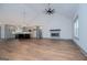 Open-concept living space featuring hardwood floors, a fireplace, and kitchen area with a dark-colored island at 5525 Belle Meade Dr, Villa Rica, GA 30180