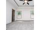 Well-lit main bedroom with carpet, ceiling fan, and window views at 5525 Belle Meade Dr, Villa Rica, GA 30180