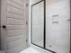 Modern bathroom shower with white tile and a sleek glass enclosure at 5525 Belle Meade Dr, Villa Rica, GA 30180