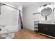 Modern bathroom features a sleek vanity, round mirror, and a shower with a stylish shower curtain at 2328 Lakewood Ave Sw, Atlanta, GA 30315