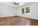 Spacious bedroom features wood-look floors, ceiling fan, and a view of the outside at 2328 Lakewood Ave Sw, Atlanta, GA 30315