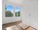 Bright bedroom featuring wood-look flooring, white walls and trim, and double windows at 2328 Lakewood Ave Sw, Atlanta, GA 30315