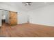 Bedroom with hardwood floors, white walls, and barn door at 2328 Lakewood Ave Sw, Atlanta, GA 30315