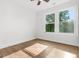 Bright bedroom featuring wood-look flooring, white walls and trim, and double windows at 2328 Lakewood Ave Sw, Atlanta, GA 30315