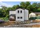 Charming two-story home featuring white siding, black trim, and a cozy front porch at 2328 Lakewood Ave Sw, Atlanta, GA 30315
