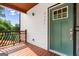 Inviting front porch with wooden railings, a green front door with glass, and the house number at 2328 Lakewood Ave Sw, Atlanta, GA 30315