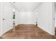 Hallway with hardwood floors, white walls, and white doors at 2328 Lakewood Ave Sw, Atlanta, GA 30315
