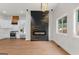 Modern kitchen featuring stainless steel appliances, white cabinets, and a decorative fireplace wall at 2328 Lakewood Ave Sw, Atlanta, GA 30315