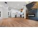 Modern open kitchen with stainless steel appliances, white cabinetry, and a decorative fireplace wall at 2328 Lakewood Ave Sw, Atlanta, GA 30315
