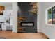 Modern kitchen with stainless steel appliances, white cabinets, and a decorative fireplace wall at 2328 Lakewood Ave Sw, Atlanta, GA 30315