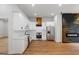 Modern kitchen featuring white cabinets, stainless steel appliances, and a stylish wood range hood at 2328 Lakewood Ave Sw, Atlanta, GA 30315