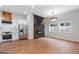 Open-concept living room with hardwood floors, a modern fireplace, and stainless steel appliances at 2328 Lakewood Ave Sw, Atlanta, GA 30315