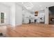 Spacious living room and kitchen with hardwood floors, stainless steel appliances, and a modern light fixture at 2328 Lakewood Ave Sw, Atlanta, GA 30315