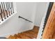 Staircase featuring wood stairs, white risers, and a black metal handrail at 2328 Lakewood Ave Sw, Atlanta, GA 30315