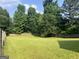 Lush green backyard with a wooden fence, offering privacy and space for outdoor enjoyment at 740 Pebble Blvd, Covington, GA 30016