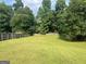 Expansive backyard with lush green grass and mature trees, perfect for outdoor activities and entertaining at 740 Pebble Blvd, Covington, GA 30016