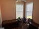 Comfortable bedroom with a pair of windows, laminate flooring, and versatile use as a home office or study at 740 Pebble Blvd, Covington, GA 30016