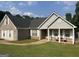 Attractive brick and siding home with a covered porch, offering curb appeal and outdoor comfort at 740 Pebble Blvd, Covington, GA 30016