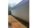 A close exterior side view of the property showcasing light siding and foundation at 740 Pebble Blvd, Covington, GA 30016